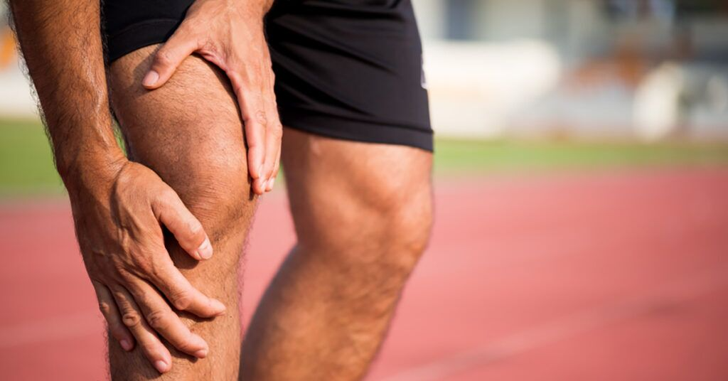 Man holding his knee